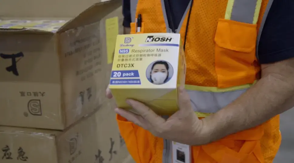 After a long delay, N95 masks are delivered to the United States from China. Image by PBS Frontline. United States, 2020.