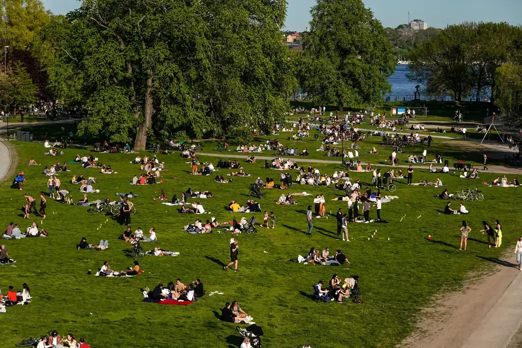 People in Stockholm's Ralambshovspark on a summer day during the coronavirus pandemic. Image by Alexanderstock23 / Shutterstock. Sweden, 2020. People in Stockholm's Ralambshovspark on a summer day during the coronavirus pandemic. Image by Alexanderstock23 / Shutterstock. Sweden, 2020.
