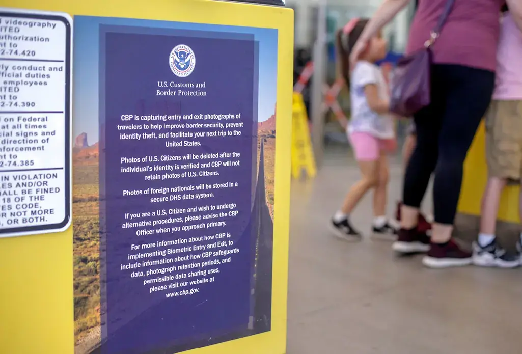 A sign explains how photos of border crossers are being used. Image by Kathleen Flynn. United States, 2019.