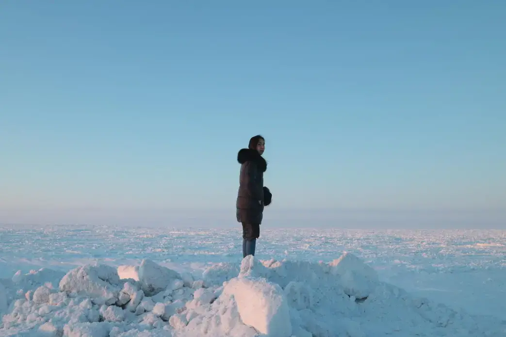 Coffee & Quaq podcast host Alice Qannik Glenn overlooks the frozen Arctic Ocean in February. Image by Jenna Kunze. United States, 2020. Coffee & Quaq podcast host Alice Qannik Glenn overlooks the frozen Arctic Ocean in February. Image by Jenna Kunze. United States, 2020.
