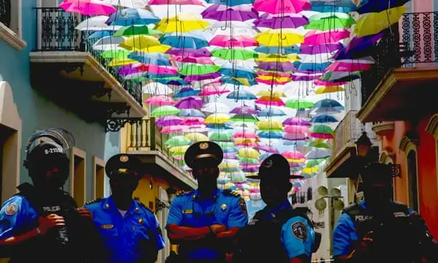 Police guard the governor’s mansion entrance on 14 July 2019 in Old San Juan, Puerto Rico. Photograph: Jose Jimenez/Getty Images Media file: dominican-theguardian.jpg