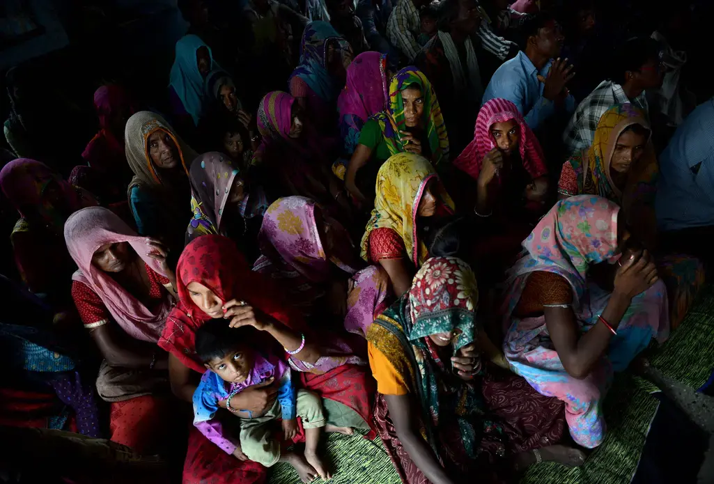 Residents of Tuvar gather in their schoolhouse to hear about the potential of bringing solar-powered electricity to the village. The village in rural northwestern India uses kerosene and firewood for energy. Image by Michael Henninger. India, 2016. powered electricity to the village. The village in rural northwestern India uses kerosene and firewood for energy. Image by Michael Henninger. India, 2016.