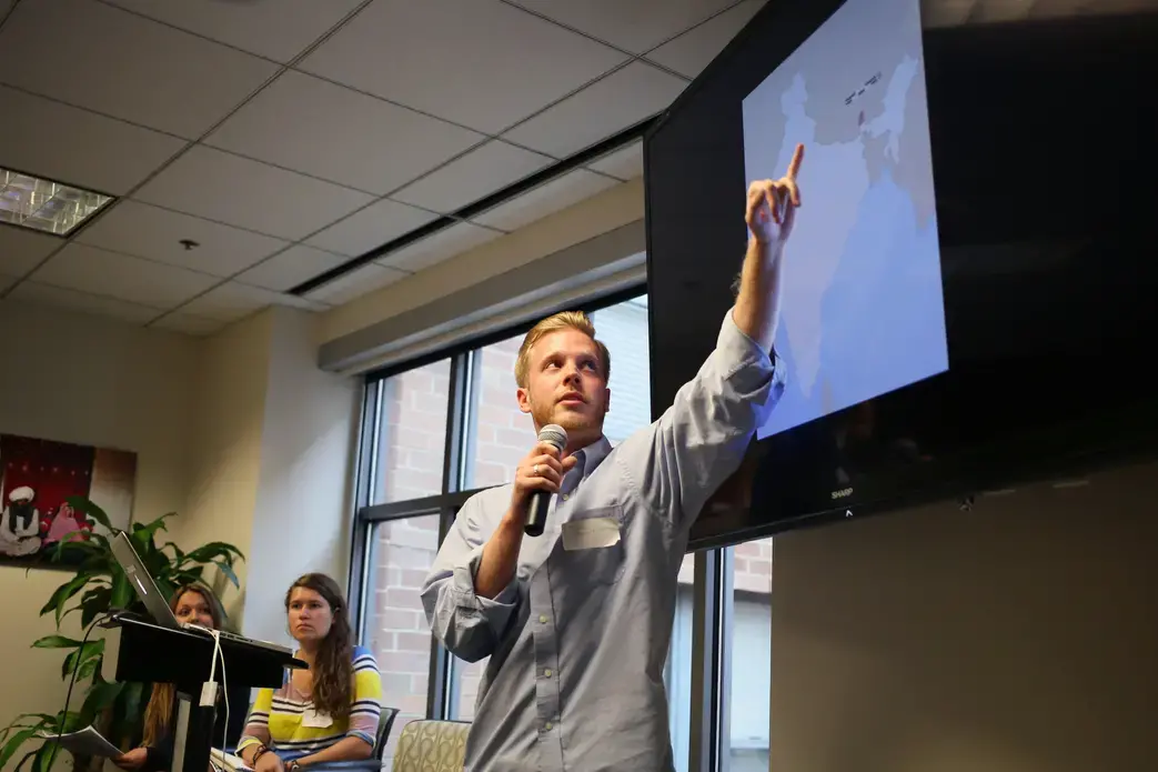 Guilford College student fellow Tom Clement presents his project on damming a sacred river in India. Image by Meghan Dhaliwal. Washington, DC, 2014. Media file: 3.jpg