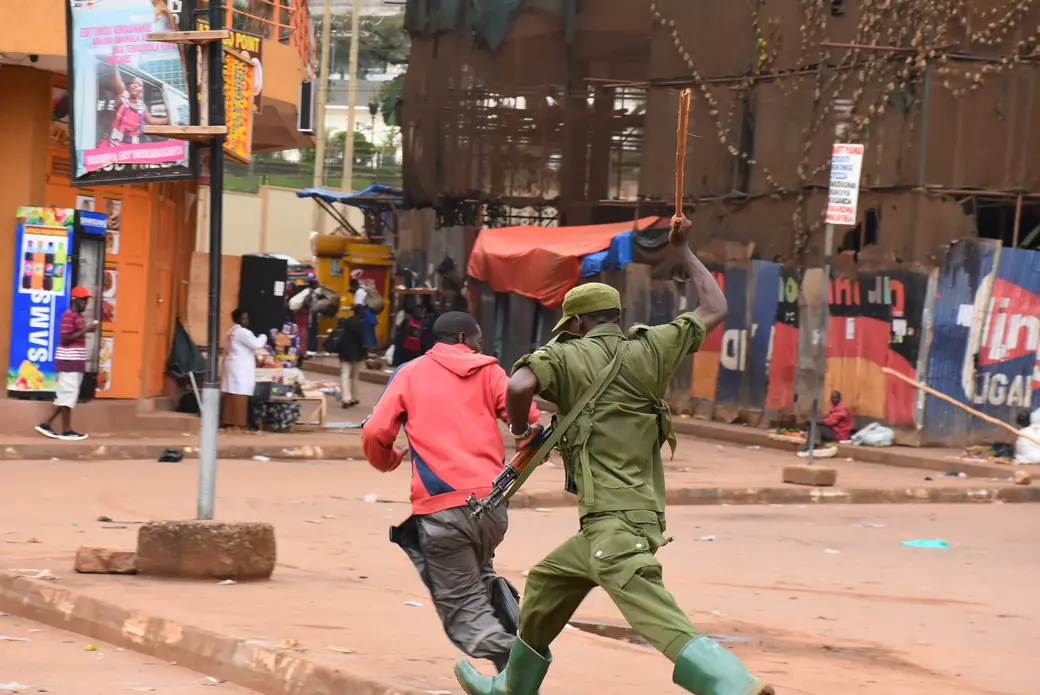 An LDU soldier beats a person during implementation of coronavirus restrictions in Kampala in March. Image by Alex Esagala. Uganda, 2020. An LDU soldier beats a person during implementation of coronavirus restrictions in Kampala in March. Image by Alex Esagala. Uganda, 2020.