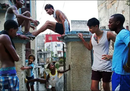From left, Yosuan Gonzalez, 15, Lazaro Gutierrez, 16, Lorenzo Velasquez, 13, Noel Sandoval, 19, and a friend hanging out in Havana with Emily Chanti, 4, and Yesena Kagemusa, 6. Image by Yana Paskova. Cuba, 2015. Media file: screen_shot_2015-08-13_at_1.36.16_pm.jpg