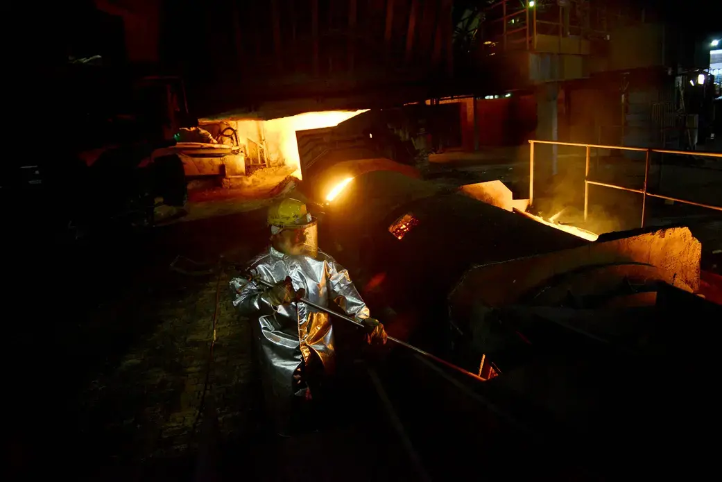 A Tata Steel worker checks the temperature of the one of the plant's seven blast furnaces during an afternoon. Image by Michael Henninger. India, 2016. A Tata Steel worker checks the temperature of the one of the plant's seven blast furnaces during an afternoon. Image by Michael Henninger. India, 2016.