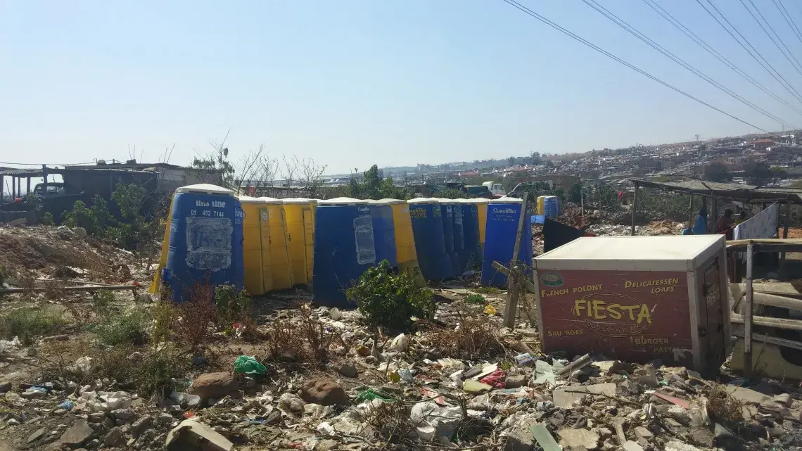 Trash piled up around Setswetla's chemical toilets. Image by Christian Belanger, South Africa, 2016.