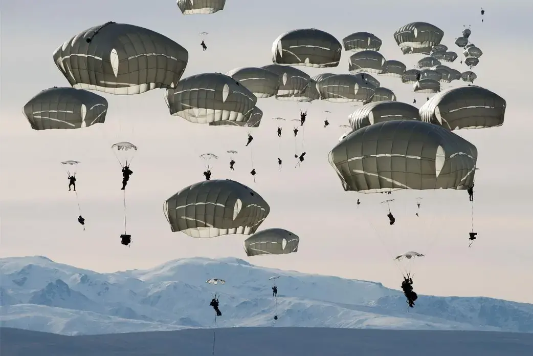 U.S. soldiers drop over the Donnelly Training Area near Fort Greely, Alaska. In October 2018, the training area hosted some 6,000 soldiers during a war games exercise named Arctic Anvil. Image by Louie Palu. United States, 2018. U.S. soldiers drop over the Donnelly Training Area near Fort Greely, Alaska. In October 2018, the training area hosted some 6,000 soldiers during a war games exercise named Arctic Anvil. Image by Louie Palu. United States, 2018.