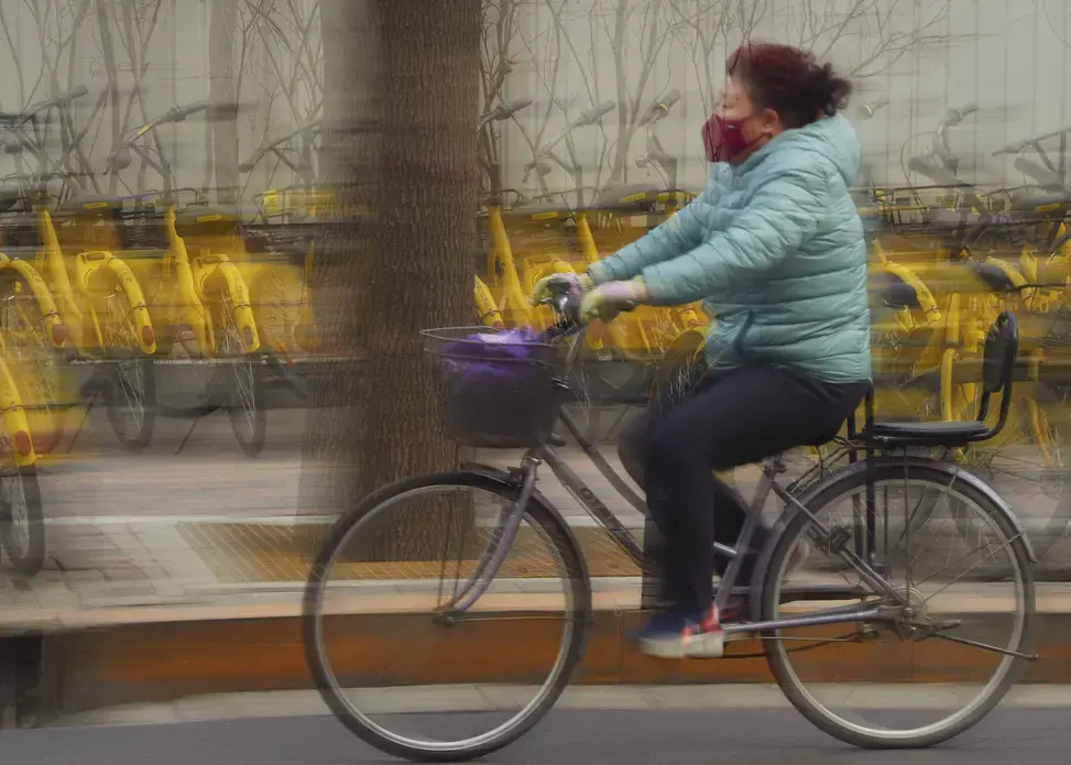 In the northern industrial city of Shijiazhuang, commuters often wear protective gear to inhibit the inhalation of particulate pollution. It’s a persistent battle. Image by Larry C. Price. China, 2018.