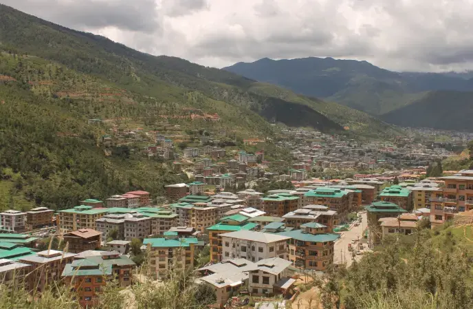 Thimphu is the capital city of Bhutan, located in the western part of the country. It is a city of about 115,000 people in a country with 750,000 people in total. The city has developed rapidly in the past few decades and continues to expand. Image by Emma Johnson. Bhutan, 2019. Thimphu is the capital city of Bhutan, located in the western part of the country. It is a city of about 115,000 people in a country with 750,000 people in total. The city has developed rapidly in the past few decades and continues to expand. Image by Emma Johnson. Bhutan, 2019.