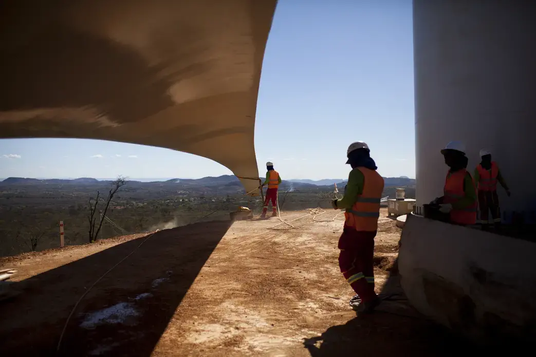 Workers prepare wind blades to be hoisted onto a new tower at the High Wilderness Wind Complex in Caetite. It is one of many wind-turbine parks being constructed across the country, in what planners here see as the beginning of an extraordinary transformation. Image by Lianne Milton /For The Washington Post. Brazil, 2013. Media file: 20131025windpower5341382753346.jpg