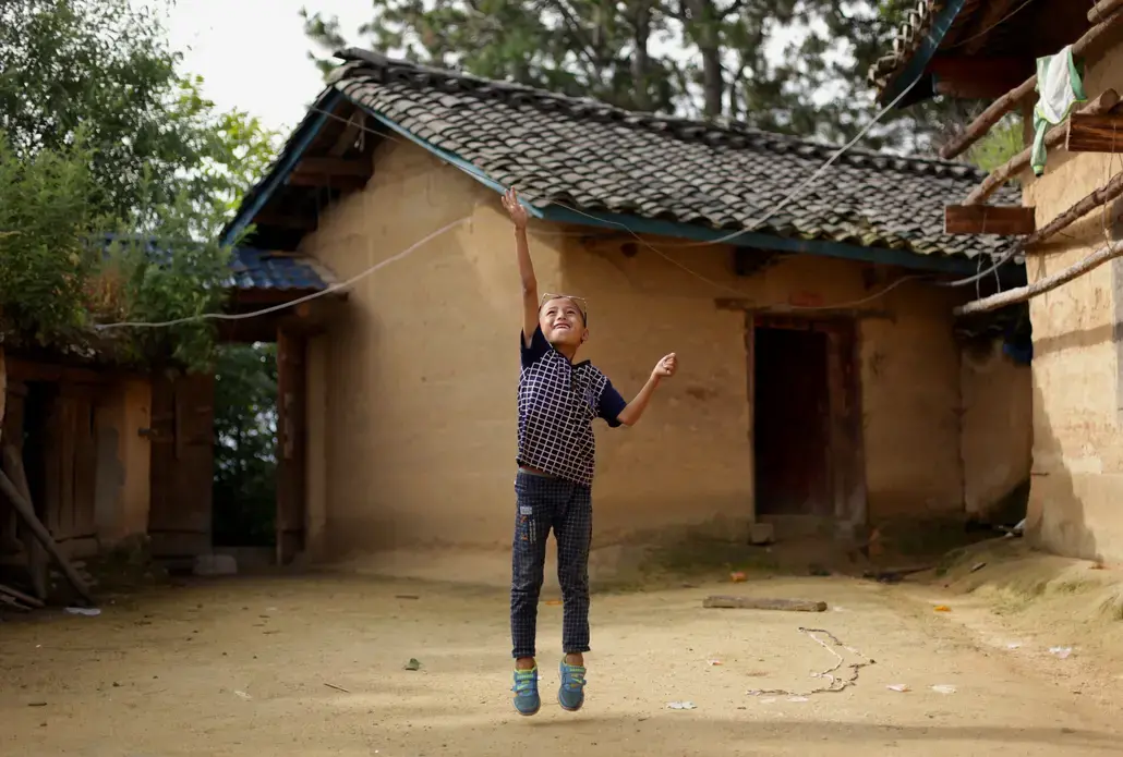 Eight-year-old Wang Jie plays in the courtyard of his family's farmhouse in Liangshan prefecture, Sichuan province. Image by Max Duncan. China, 2016. Eight-year-old Wang Jie plays in the courtyard of his family's farmhouse in Liangshan prefecture, Sichuan province. Image by Max Duncan. China, 2016.