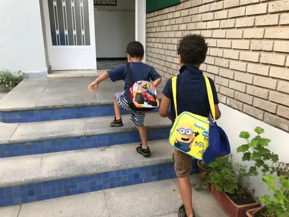 The author's sons, ages 5 and 3, walk up the stairs at their private French school in Morocco. The boys are autistic. Image by Jackie Spinner. Morocco, 2017. The author's sons, ages 5 and 3, walk up the stairs at their private French school in Morocco. The boys are autistic. Image by Jackie Spinner. Morocco, 2017.