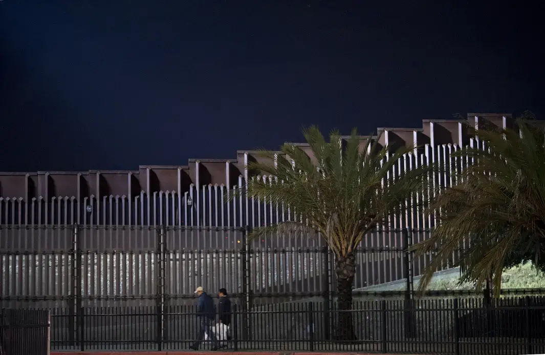 Pedestrians stroll near the border wall on foot from the United States side Nov. 27. Image by Amanda Cowan. United States, 2019.