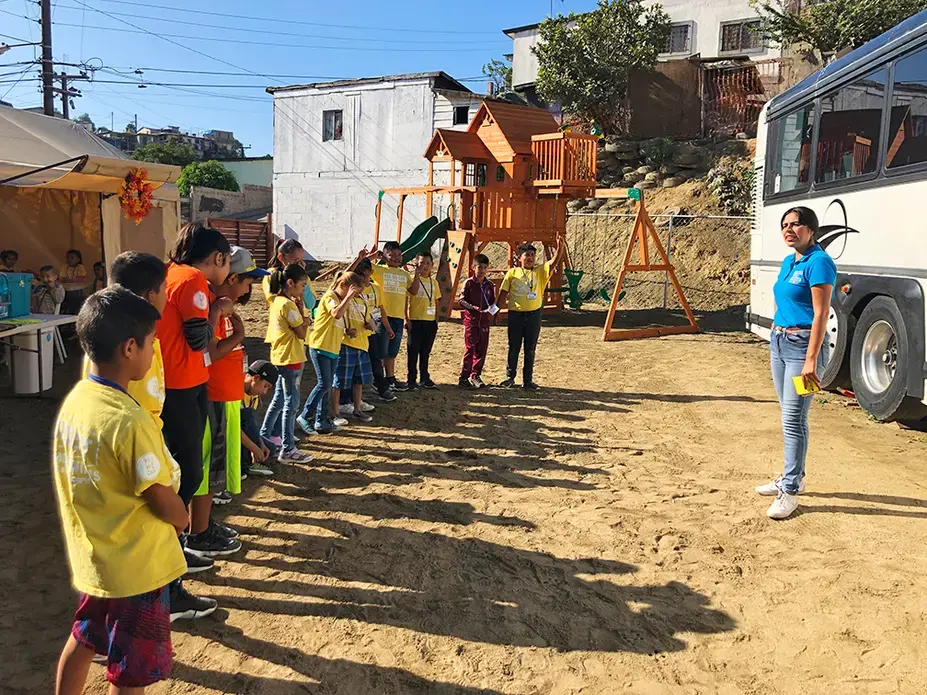 Teacher Sandra Rodríguez greets students at the Yes We Can World Foundation school in Tijuana, Mexico, on October 3. Image by Jaime Joyce. Mexico, 2019. Teacher Sandra Rodríguez greets students at the Yes We Can World Foundation school in Tijuana, Mexico, on October 3. Image by Jaime Joyce. Mexico, 2019.