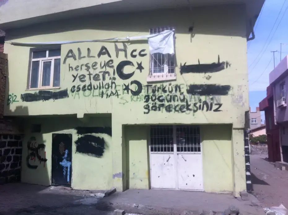 A graffiti-daubed house in the old walled city, in Diyarbakir, the main city in the Kurdish-majority southeast of Turkey. The graffiti says, 'you will see the strength of the Turk,' as well as exhortations to God, and was left by Turkish soldiers who recently fought running battles with Kurdish nationalists who had declared the walled city an autonomous zone. Image by Christopher de Bellaigue. Turkey, 2015. A graffiti-daubed house in the old walled city, in Diyarbakir, the main city in the Kurdish-majority southeast of Turkey. The graffiti says, 'you will see the strength of the Turk,' as well as exhortations to God, and was left by Turkish soldiers who recently fought running battles with Kurdish nationalists who had declared the walled city an autonomous zone. Image by Christopher de Bellaigue. Turkey, 2015.