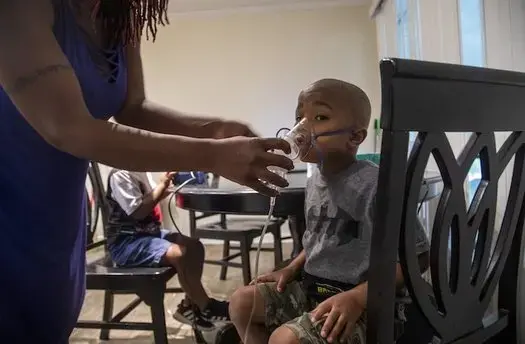 Four-year-old Jeremiah Galbreath receives a nebulizer treatment for asthma at his home in Bayboro. Image by Travis Long / The News &amp; Observer. United States, 2020.