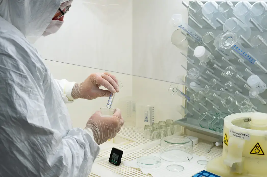 A scientist in a laboratory studying and analyzing samples for vaccines with glass vials. Image by Michele Ursi / Shutterstock. Lithuania, 2020. A scientist in a laboratory studying and analyzing samples for vaccines with glass vials. Image by Michele Ursi / Shutterstock. Lithuania, 2020.
