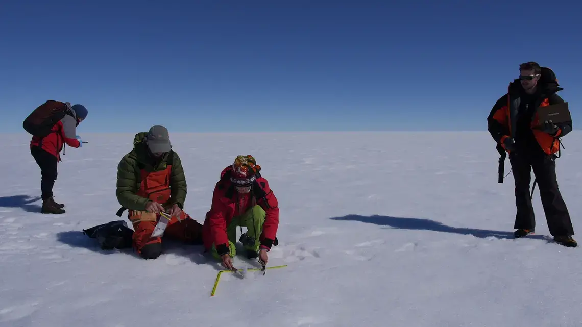 Scientists take measurements on the surface of the Greenland ice sheet. Image by Eli Kintisch. Greenland, 2016.