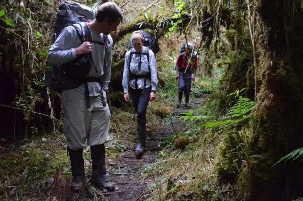 Image by Justin Catanoso. Peru, 2013. Media file: catanoso-was-weighed-down-by-a-heavy-pack-but-the-more-experienced-hikers-had-heavier-packs-as-they-followed-a-trail-cut-hundreds-of-years-ago-by-incans_1.jpg