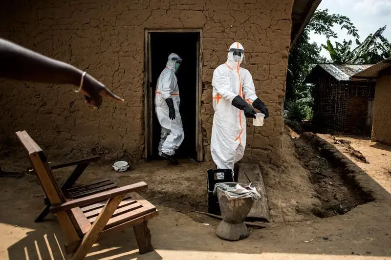 Ebola responders disinfect a home in Aloya in which three people have died. Image by John Wessels. Democratic Republic of Congo, 2019. Ebola responders disinfect a home in Aloya in which three people have died. Image by John Wessels. Democratic Republic of Congo, 2019.