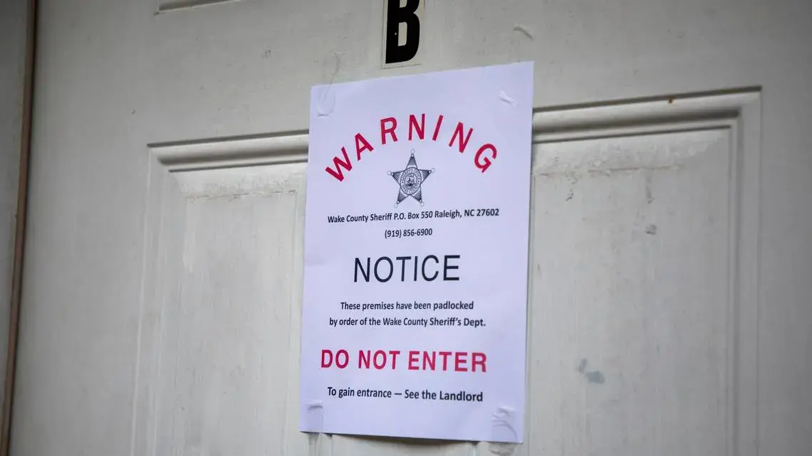 A padlock notice is taped to the door of an apartment, whose tenant was unavailable for comment, in late August in Raleigh, N.C. Image by Casey Toth. United States, 2020. A padlock notice is taped to the door of an apartment, whose tenant was unavailable for comment, in late August in Raleigh, N.C. Image by Casey Toth. United States, 2020.