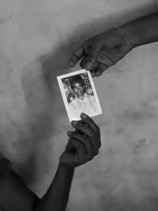 Jeyarani Vaiththeeswaran and her daughter hold a photograph of their missing son and brother Antany. Image by Moises Saman for Magnum Photos. Sri Lanka, 2018.