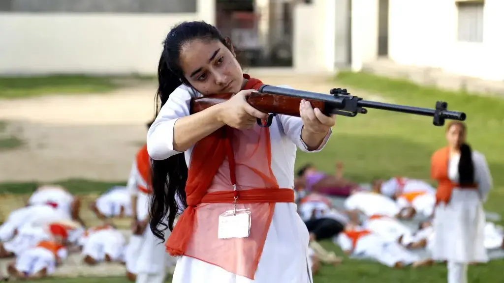 Hindu girls of the Durga Vahini, the 'saffron brigade' women's wing of the Hindu hardliner organization Vishwa Hindu Parishad (VHP), participate in a self-defense training camp, on July 7, 2017 in Jammu, India. Due to the increase in crime against women in the country, the young girls are being given training to operate sticks and guns and to develop the skills of self-defence. Image by Nitin Kanotra / Hindustan Times via Getty Images. India, 2017. Hindu girls of the Durga Vahini, the 'saffron brigade' women's wing of the Hindu hardliner organization Vishwa Hindu Parishad (VHP), participate in a self-defense training camp, on July 7, 2017 in Jammu, India. Due to the increase in crime against women in the country, the young girls are being given training to operate sticks and guns and to develop the skills of self-defence. Image by Nitin Kanotra / Hindustan Times via Getty Images. India, 2017.