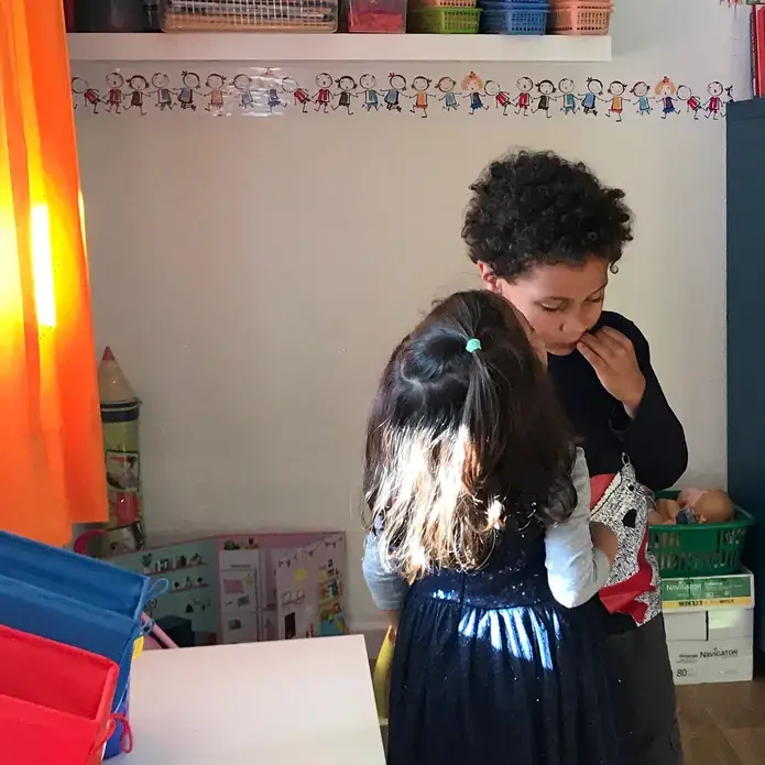 The author's 5-year-old son gets a kiss on the cheek from a kindergarten classmate on his last day of school in Morocco before returning to the United States in November. Image by Jackie Spinner. Morocco, 2017.