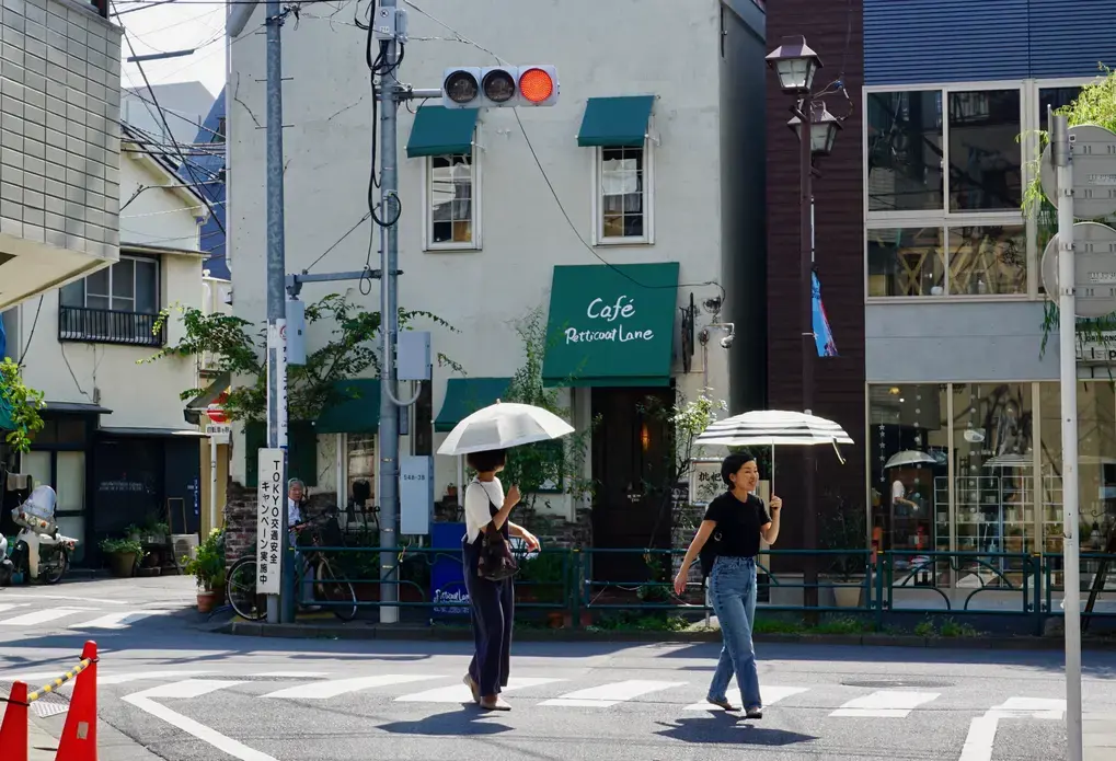 Two women walking in Tokyo with umbrellas. Image by Daniel Merino. Japan, 2019. Two women walking in Tokyo with umbrellas. Image by Daniel Merino. Japan, 2019.