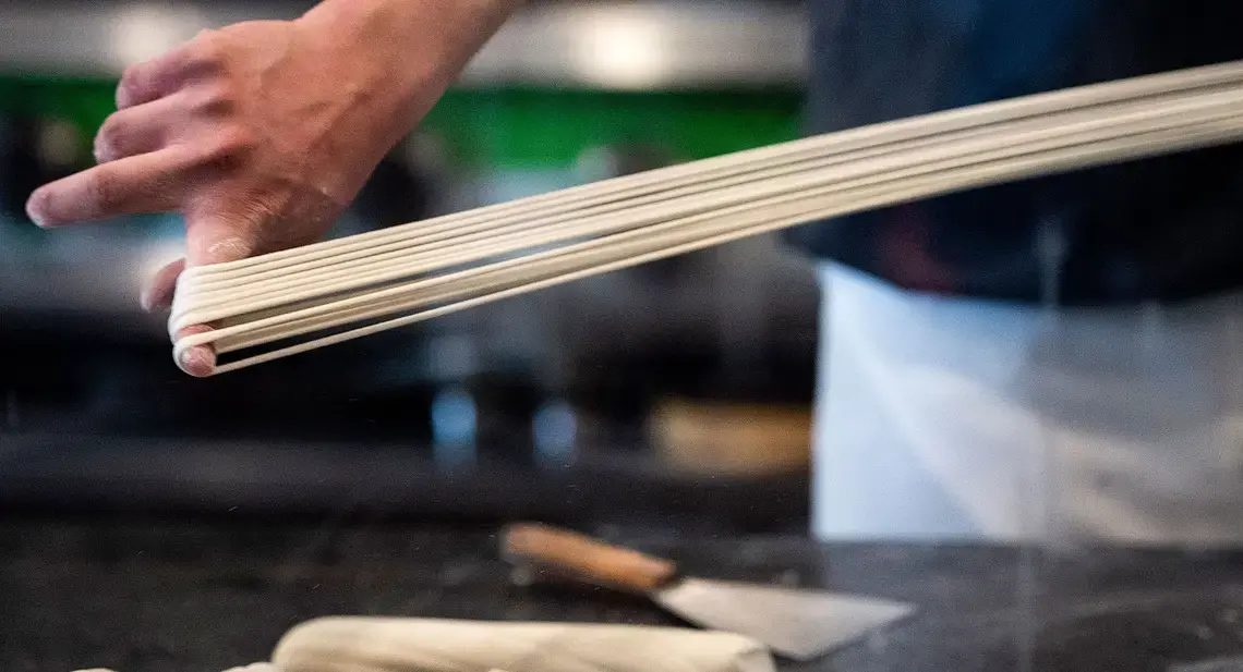 Tony Mao makes hand-pulled noodles at Everyday Noodles. Image by Stephanie Chambers. United States, 2018. Tony Mao makes hand-pulled noodles at Everyday Noodles. Image by Stephanie Chambers. United States, 2018.