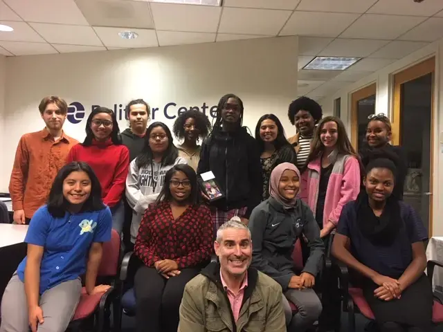 Finalists of the 2018 DCPS Study Abroad Photography Contest pose for a picture with photojournalist Louie Palu. Image by Fareed Mostoufi. United States, 2018.