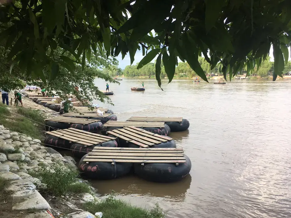 Rafts on the bank of the Suchiate River, which runs between Guatemala and Mexico. These rafts—largely ferrying market-goers and vendors—are also frequently used by U.S.-bound migrants crossing into Mexico. Image by Lauren Markham. Guatemala, 2018. Rafts on the bank of the Suchiate River, which runs between Guatemala and Mexico. These rafts—largely ferrying market-goers and vendors—are also frequently used by U.S.-bound migrants crossing into Mexico. Image by Lauren Markham. Guatemala, 2018.