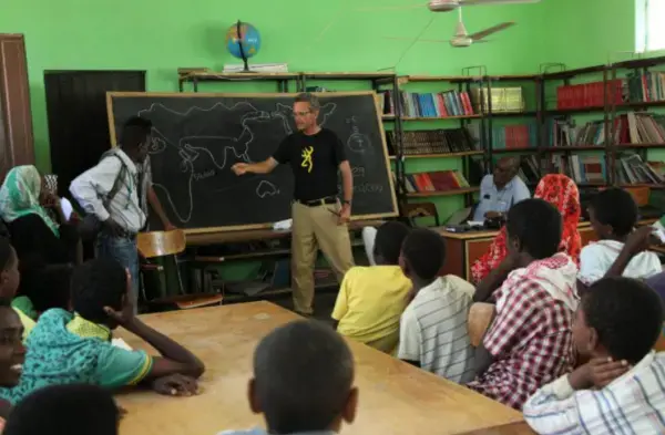 Salopek speaks to students in the Afar region of Ethiopia in February. The Afar are nomads, people who move from place to place, so their schools have to move with them. "The Ethiopian kids would give almost anything to finish their schooling," Salopek said. "They are driven." Image by John Stanmeyer / For National Geographic. Media file: salopek4.png