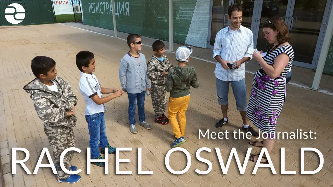 Pulitzer fellow Rachel Oswald and her fixer, Dmitry Saltykovsky, interview Russian-Tajik boys attending Patriot Park, a government-funded permanent exhibition outside of Moscow designed to showcase Russian military strength. Image by Ulia Zamiatina. Russia, 2016.