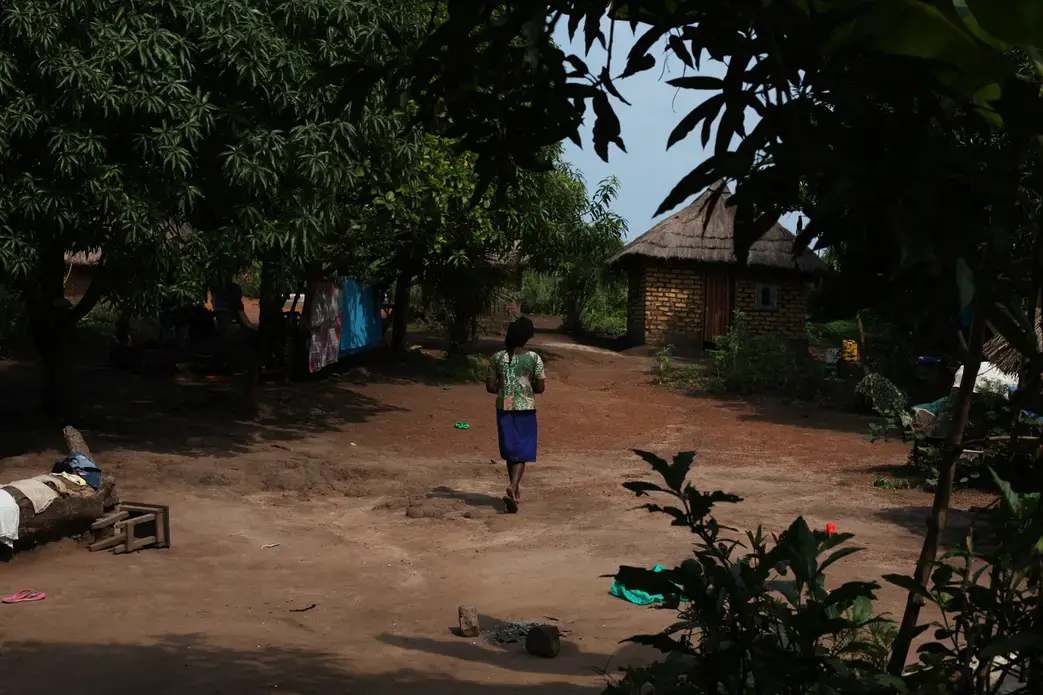 A 17-year-old mother, released by militia forces, walks around the compound where she lives with her two sisters. Like her, and like her grandmother, they were kidnapped and held by rebel soldiers. The girl was pregnant when she was released. Image by Andreea Campeanu. South Sudan, 2018. A 17-year-old mother, released by militia forces, walks around the compound where she lives with her two sisters. Like her, and like her grandmother, they were kidnapped and held by rebel soldiers. The girl was pregnant when she was released. Image by Andreea Campeanu. South Sudan, 2018.