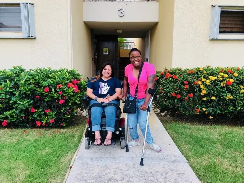 Keishla Rolón (left) and Alexis Smith in front of Keishla's home in Puerto Rico. Image by Kyja Reeves. United States, 2018. Keishla Rolón (left) and Alexis Smith in front of Keishla's home in Puerto Rico. Image by Kyja Reeves. United States, 2018.