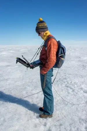 Student Aidan Stansberry collects data to help map the ice sheet bed. Image by Amy Martin. Greenland, 2018. 
