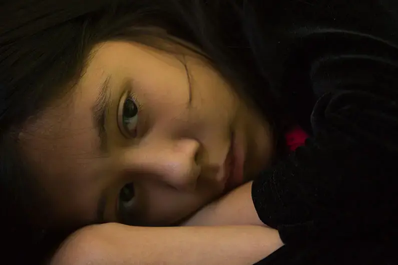 His daughter Paulina Zarazua, 10, rests at their Mexico City apartment. Image by Erika Schultz. Mexico, 2019.