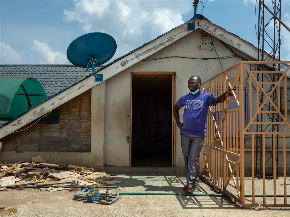 Former Uber driver Harrison Munala on the roof of his former apartment building, which his wife and their three children were evicted from in mid-August after they fell behind on their rent. Image by Nichole Sobecki/NBC News. Kenya, 2020. Former Uber driver Harrison Munala on the roof of his former apartment building, which his wife and their three children were evicted from in mid-August after they fell behind on their rent. Image by Nichole Sobecki/NBC News. Kenya, 2020.