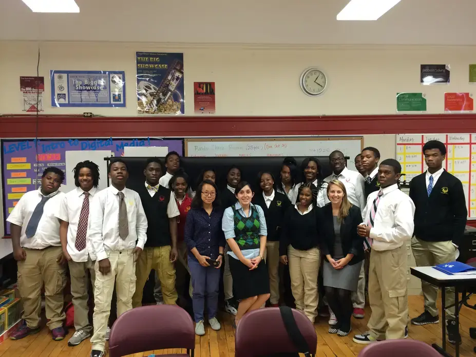 Pulitzer Center grantee Sim Chi Yin poses with educators and students at North Lawndale College Preparatory Charter High School. Image by Amanda Ottaway. Chicago, 2014. Media file: img_5460.jpg