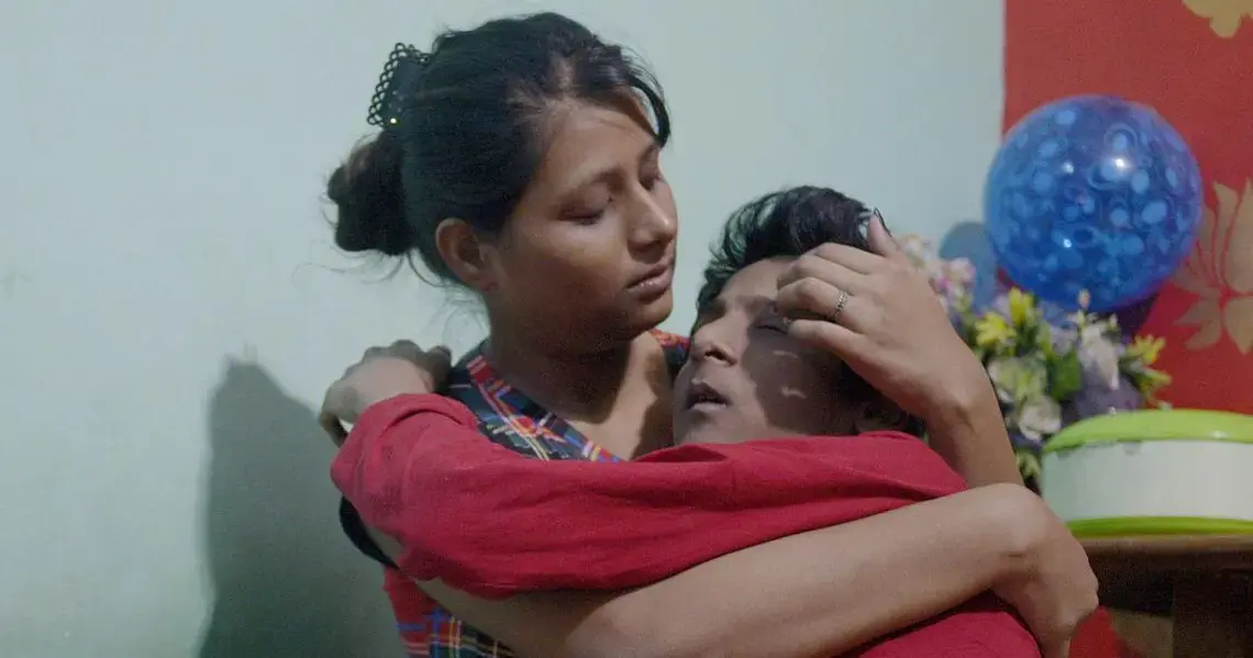 Fifteen-year-old Krishna Bhargava, who has cerebral palsy, with his sister Chanchal. Krishna loves cricket and the TV show Kaun Banega Crorepati. Image by Rohit Jain. India, 2020.