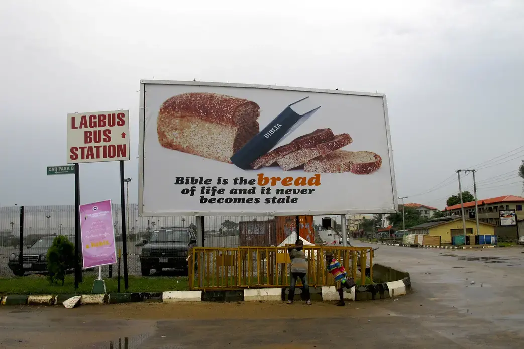 "Bible is the bread of life and it never becomes stale," notes the sign placed alongside a much smaller notice for Nigeria's Lagbus bus service. Image by Richard Vijgen. Nigeria, 2013. Media file: img_6606.jpg