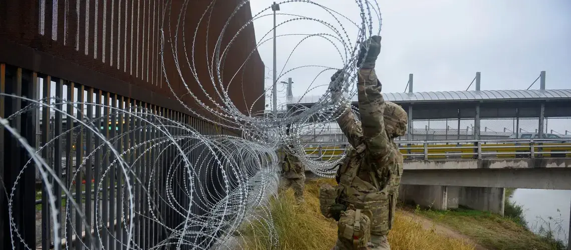 U.S. Army soldiers with the 889th Engineering Support Company, lay concertina wire along the Gateway International Bridge in Brownsville. Image courtesy of U.S. Air Force, via Reuters. United States, 2018. U.S. Army soldiers with the 889th Engineering Support Company, lay concertina wire along the Gateway International Bridge in Brownsville. Image courtesy of U.S. Air Force, via Reuters. United States, 2018.