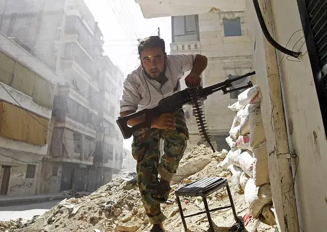 A Free Syrian Army fighter takes cover during clashes with Syrian Army in the Salaheddine neighbourhood of central Aleppo August 7, 2012. REUTERS/Goran Tomasevic courtesty Creative Commons. Syria, 2016. A Free Syrian Army fighter takes cover during clashes with Syrian Army in the Salaheddine neighbourhood of central Aleppo August 7, 2012. REUTERS/Goran Tomasevic courtesty Creative Commons. Syria, 2016.