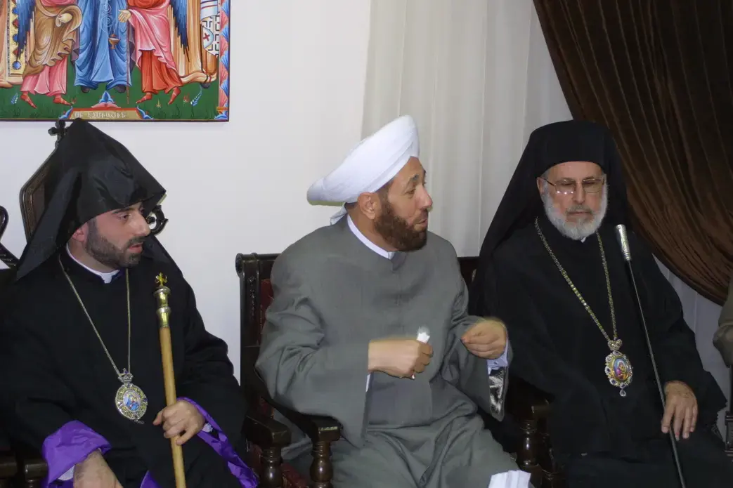 Christian and Muslim clerics gather at a funeral for four children killed by rebel mortars. Image by (c) Reese Erlich. Syria, 2013. Media file: 3_clerics.jpg