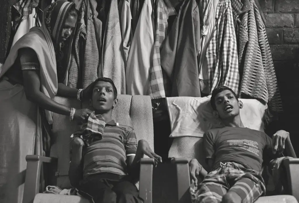 Living victims: Vikas Yadav, 19, and Aman Yadav, 17, brothers, have muscular dystrophy and are being cared for by their mother at their home. Affected by toxic waste which seeped into the groundwater, they will live short, painful lives. Image by Rohit Jain. India, 2018. Living victims: Vikas Yadav, 19, and Aman Yadav, 17, brothers, have muscular dystrophy and are being cared for by their mother at their home. Affected by toxic waste which seeped into the groundwater, they will live short, painful lives. Image by Rohit Jain. India, 2018.