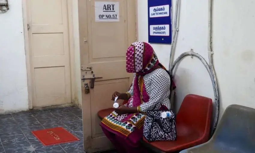 An HIV-positive woman peels the labels off her medication at the government ART center so that her family members will not discover her HIV status. Image by Aditi Kantipuly. India, 2016. An HIV-positive woman peels the labels off her medication at the government ART center so that her family members will not discover her HIV status. Image by Aditi Kantipuly. India, 2016.