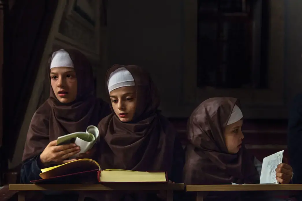 Albanian children studying the Koran. Image by Monika Bulaj. Kosovo, 2013. Albanian children studying the Koran. Image by Monika Bulaj. Kosovo, 2013.