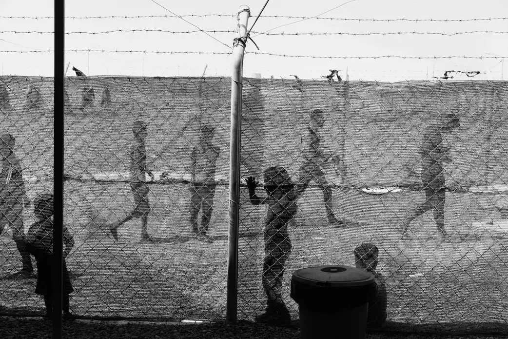 Thousands of men and boys have been convicted of ISIS affiliation, and hundreds have been hanged. But these cases make up only a small fraction of the detainees. Thousands of families have been sent to camps in the desert, cast out from society. Moises Saman / Magnum for The New Yorker. Iraq, 2018. Thousands of men and boys have been convicted of ISIS affiliation, and hundreds have been hanged. But these cases make up only a small fraction of the detainees. Thousands of families have been sent to camps in the desert, cast out from society. Moises Saman / Magnum for The New Yorker. Iraq, 2018.